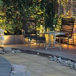 Un classico giardino con prato all'inglese e un'illuminazione molto semplice