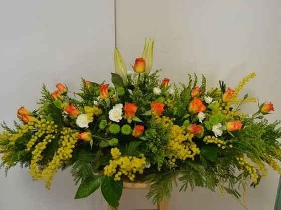 Composizione di mimose con boccioli di rosa